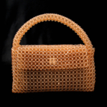 Luxury natural stone bag handcrafted using approximately 2300 pieces of 7mm facet cut zultanite stones that change color according to light.