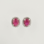 A luxury designer earrings made of original oval cut red ruby gemstones set in a 925 sterling silver halo with sparkling zircon accents.