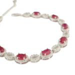 A luxury designer bracelet made of original oval cut red ruby gemstones set in 925 sterling silver with sparkling zircon accents.