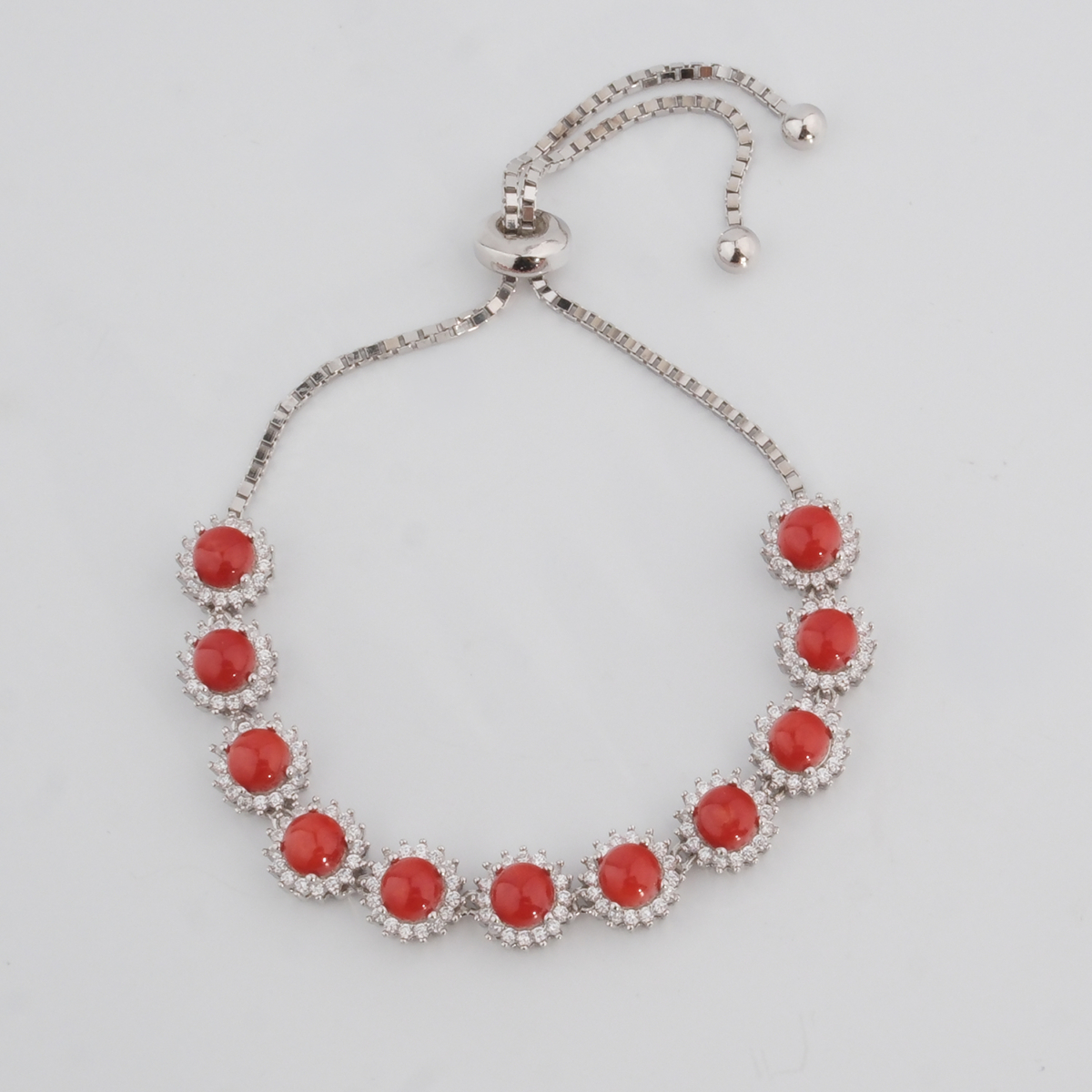 A luxury 925 sterling silver slider bracelet featuring 9 red coral stones enclosed in round cubic zirconia frames, shown in DSCF0676.jpg.