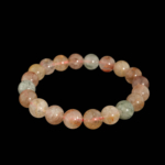 Flexibles Natursteinarmband aus 9-10mm runden, glatten klaren Quarzperlen mit bunten Rutil-Einschlüssen.