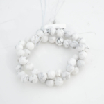 Faceted cut original veined howlite natural stone strand in 8mm size prepared for jewelry design.