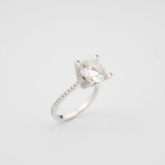 A luxury solitaire designer ring featuring a certified 2 carat D color VVS1 round brilliant moissanite gemstone set in a four-prong 925 sterling silver band with a GRA certificate.