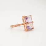 A luxury women's statement ring featuring an original emerald cut ametrine gemstone set in rose gold-plated 925 sterling silver with textured band design.