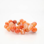 12mm carnelian agate natural stone bead strand in orange tones.