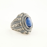 925 sterling silver men's ring featuring an oval cabochon cut original star sapphire natural stone and masterfully engraved surroundings.