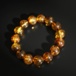 Bracciale di ambra baltica originale da 13-14mm a sfere lisce per adulto con sfumature cognac.
