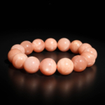 A stylish gemstone statement bracelet featuring original 15-16mm 4A+ grade sunstone round beads on a stretch band.