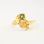 A luxury women's statement ring featuring an original round faceted peridot gemstone set in a gold-plated 925 sterling silver artisan rose design.