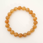 A stylish gemstone statement bracelet featuring original 8-9mm yellow and orange tourmaline round beads on a stretch band.
