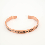 A handcrafted thin pure copper cuff bracelet featuring an engraved geometric chain link pattern with black oxidation.