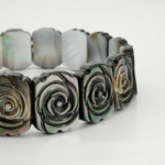 An authentic hand-carved grey black mother of pearl rose design rolex cut stretch bracelet.