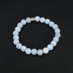 An 8mm natural round blue aquamarine gemstone stretch bracelet featuring an engraved accent bead.
