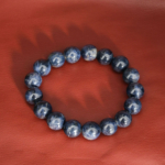 A natural deep blue sapphire gemstone stretch bracelet featuring smooth 12-13mm round beads.
