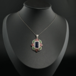 Natural baguette blue sapphire with pink tourmaline, green tsavorite and diamond halo pendant necklace in 925 sterling silver.