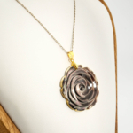 An authentic hand-carved grey mother of pearl rose pendant necklace with gold plated stainless steel chain.