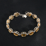 A luxurious 15+4cm 925 sterling silver women's tennis bracelet featuring oval faceted natural golden yellow citrine gemstones.