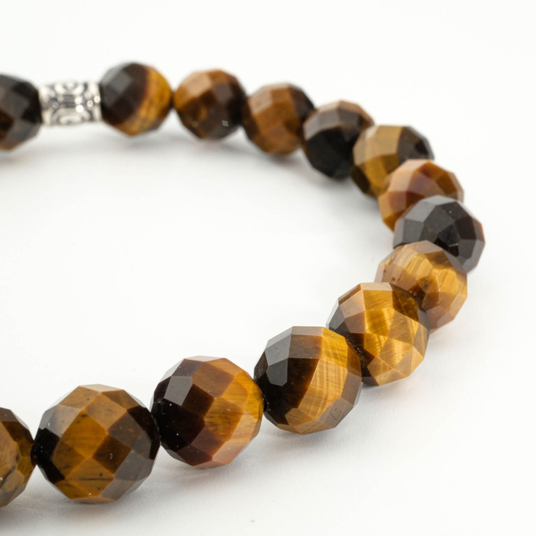 An authentic 8mm faceted cut natural tiger's eye beaded stretch bracelet with silver tone accent.