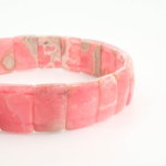 An authentic premium 5A+ grade natural pink rhodochrosite rolex cut stretch bracelet.