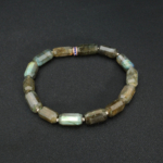 An authentic natural labradorite 6.5x11.5mm faceted cylinder gemstone stretch bracelet with 925 silver beads.