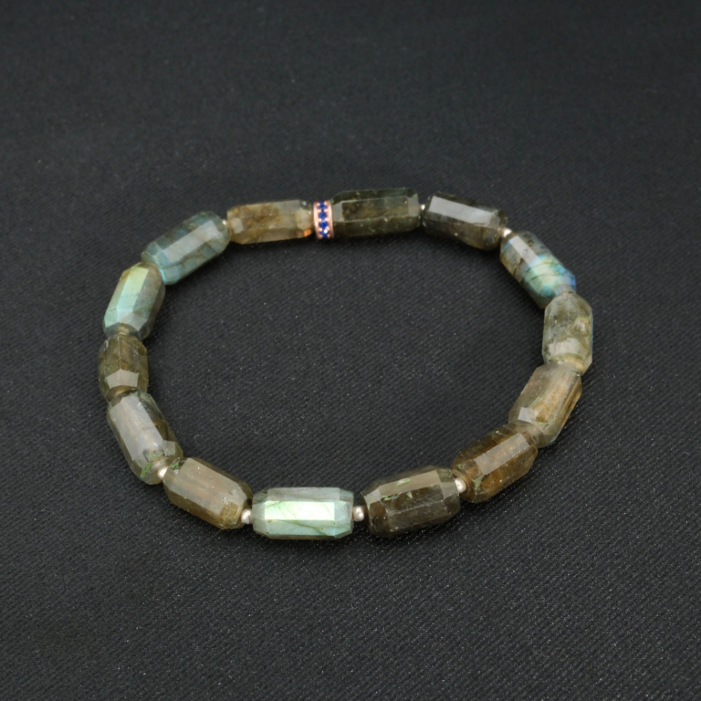 An authentic natural labradorite 6.5x11.5mm faceted cylinder gemstone stretch bracelet with 925 silver beads.