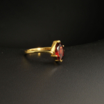 A gold-plated 925 sterling silver women's ring featuring a natural marquise-shaped faceted red garnet gemstone in a prong setting.