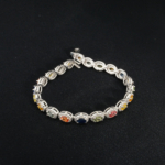A luxurious 18cm 925 sterling silver women's tennis bracelet featuring colorful oval faceted natural sapphire halo stones.