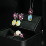 A luxurious 925 silver women's jewelry set with cabochon opal and floral pink tourmaline gemstone accents.