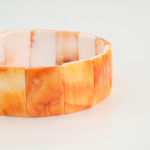 An authentic natural orange mother of pearl rolex cut beaded stretch bracelet.