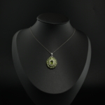 Faceted natural light green peridot gemstone flower cluster pendant necklace in 925 sterling silver on white silk.