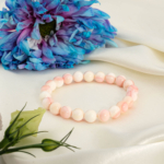 An authentic 8-9mm natural pink queen opal smooth round gemstone beads stretch bracelet.