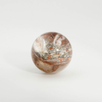 An authentic 5-5.7cm natural lodolite garden quartz crystal sphere with golden pyrite inclusions.