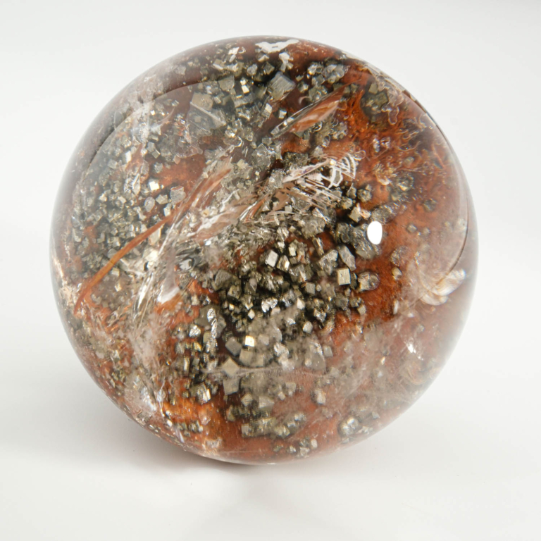 An authentic 5.6-6cm natural lodolite garden quartz crystal sphere with golden pyrite inclusions.