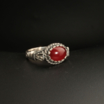 A handcrafted 925 sterling silver unisex ring featuring a vibrant red Ottoman amber gemstone in a horizontal bezel setting.
