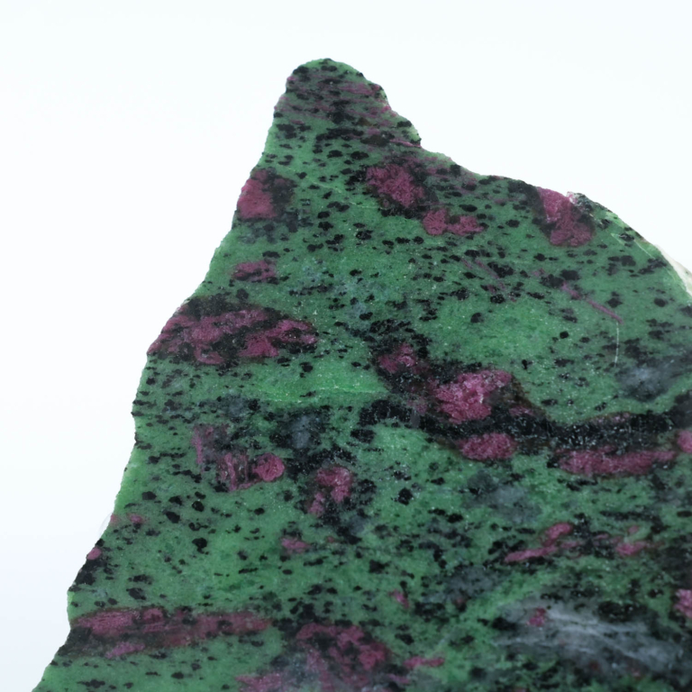 An authentic 1366g natural ruby in zoisite anyolite raw polished display slab on an acrylic stand.