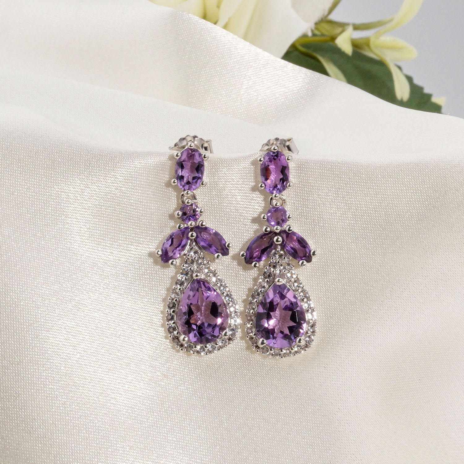 original-amethyst-natural-stone-925-sterling-silver-dangle-earrings A pair of original amethyst natural stone 925 sterling silver drop dangle earrings with zircon halo accents.