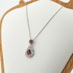 925 sterling silver women design necklace featuring a pear cut red natural garnet gemstone.