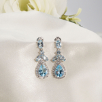 Damla kesim orijinal blue topaz doğal taş zirkon detaylı 925 ayar gümüş sallantılı kadın küpe modeli.