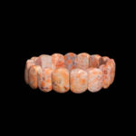 Pulsera de corte ovalado rolex de piedra natural de coral fósil original en tonos naranja y teja con patrones fósiles moteados.