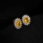 A pair of original yellow sapphire natural stone 925 sterling silver stud earrings with zircon halo setting.