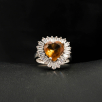 An authentic natural color-change faceted heart-cut zultanite gemstone 925 sterling silver baguette halo ring.