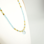Collier pour femme en argent 925 orné d'une topaze bleue taillée en poire, de péridot et d'hématite dorée.