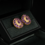 A luxurious pair of gold-plated 925 sterling silver stud earrings featuring floral halo faceted natural purple amethyst gemstones.