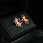 A luxurious pair of gold-plated 925 sterling silver stud earrings featuring floral halo faceted natural purple amethyst gemstones.