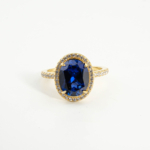 An authentic 5.20ct natural oval faceted blue sapphire gemstone 925 sterling silver gold plated halo ring.