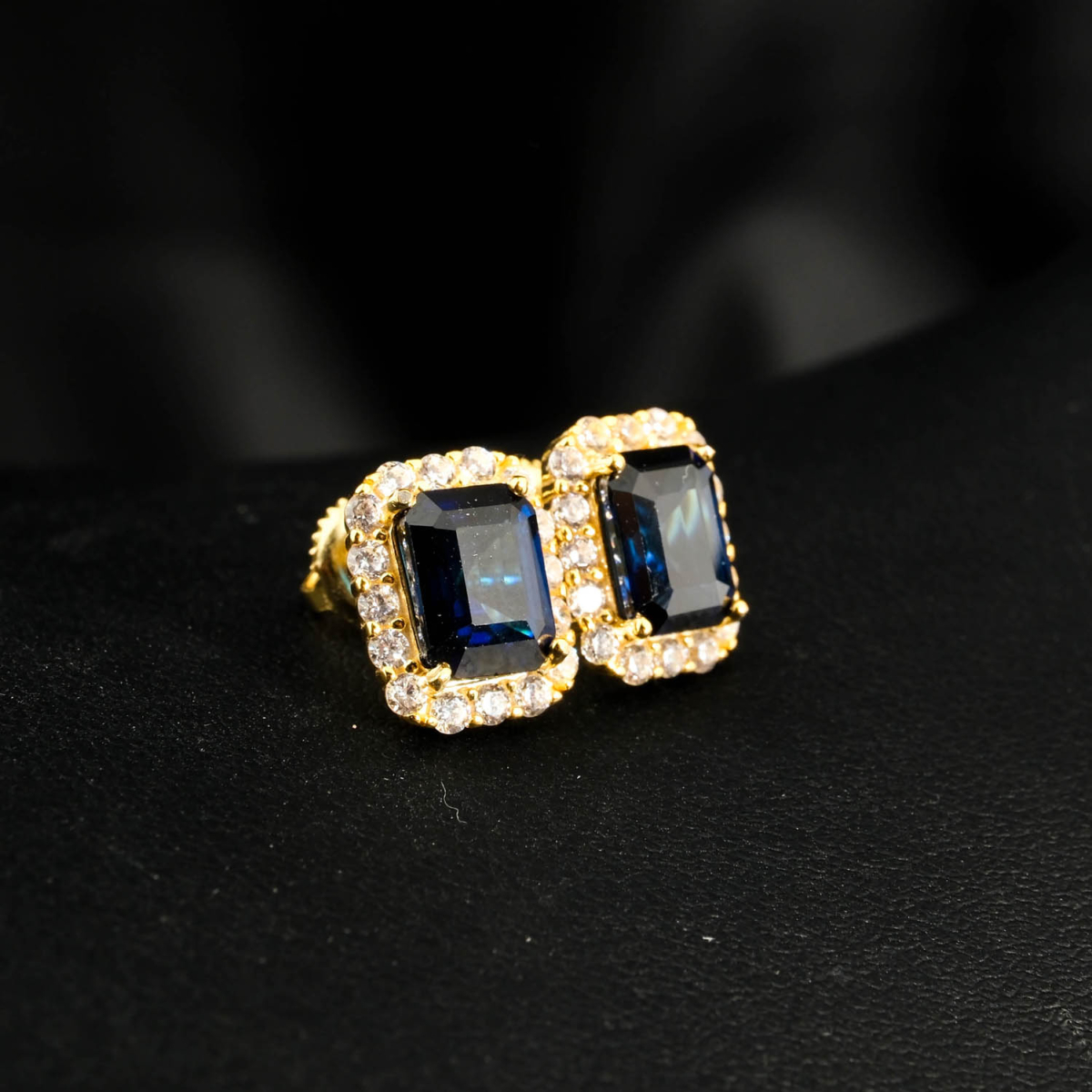 An authentic natural 3.95ct emerald-cut blue sapphire gemstone 14k gold plated 925 silver halo stud earrings.