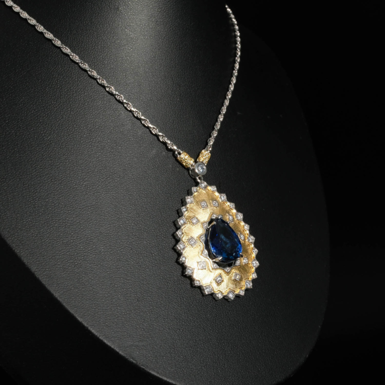 An authentic 8.25ct natural pear cut royal blue sapphire gemstone 925 sterling silver artisan medallion necklace.