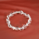 An authentic natural clear crystal quartz nugget gemstone stretch bracelet with a flower bead.