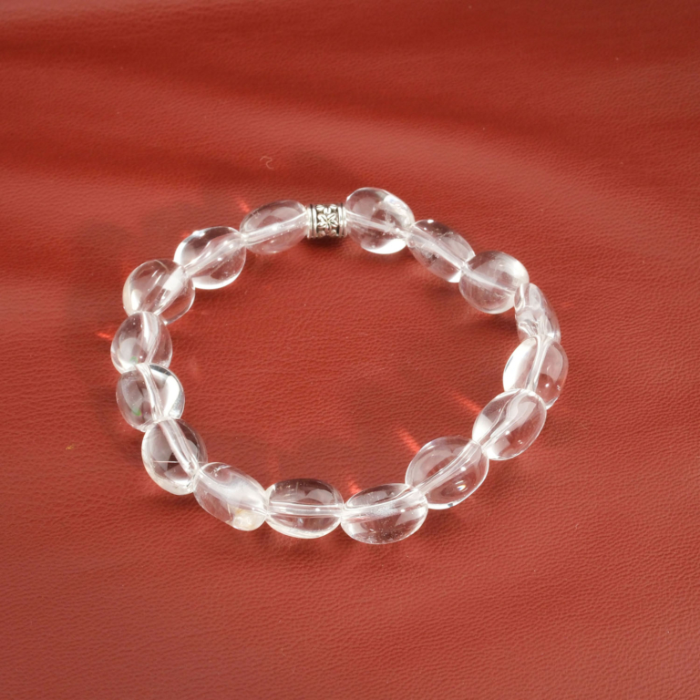 An authentic natural clear crystal quartz nugget gemstone stretch bracelet with a flower bead.