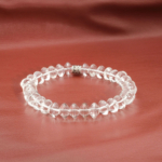An authentic natural clear crystal quartz 5.5x9mm rondelle gemstone stretch bracelet with metal spacer.